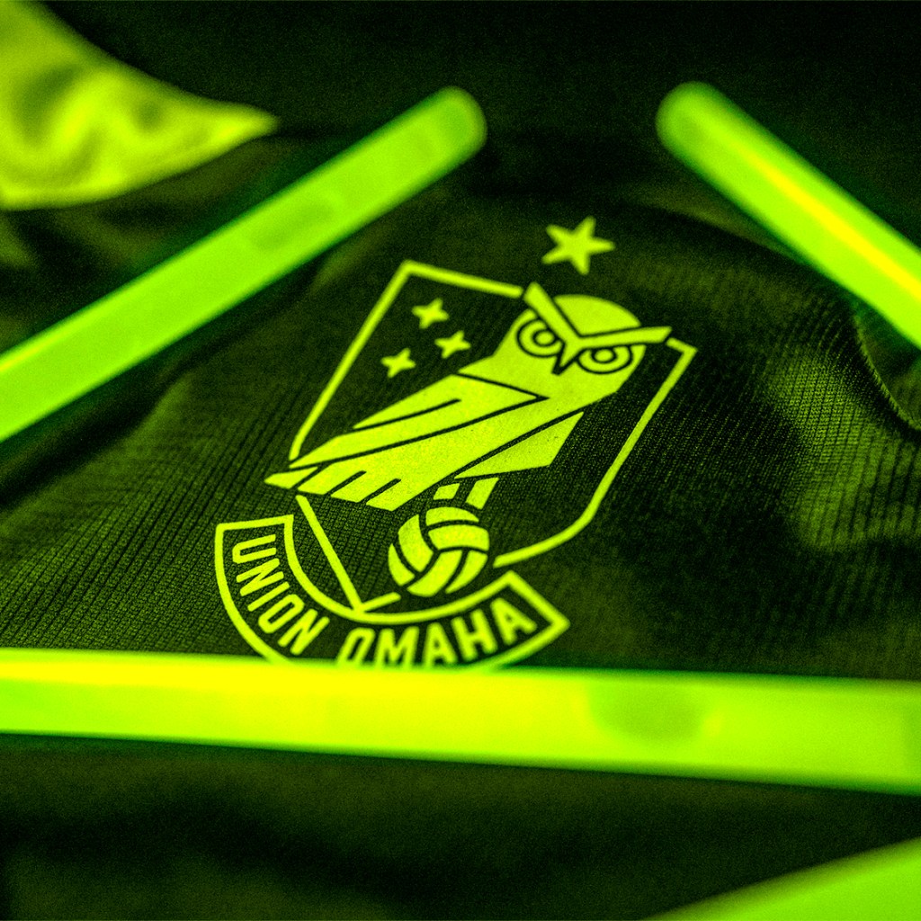 The crest on Union Omaha's new 2024 Hummel primary jersey, surrounded by glow sticks.