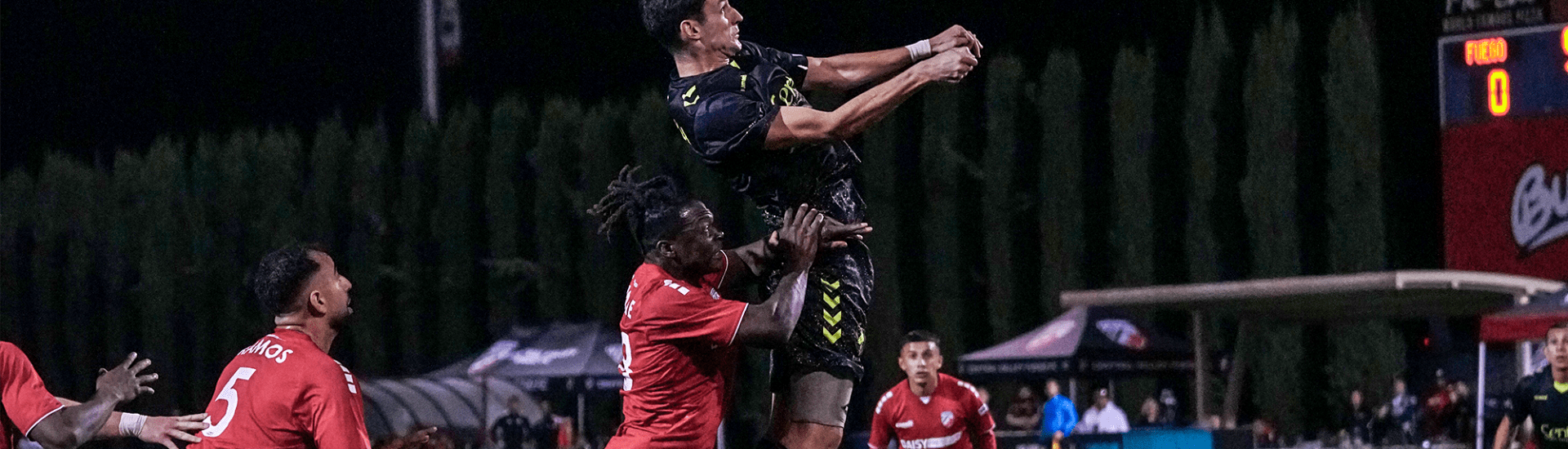 Union Omaha player going up for a header against Central Valley Fuego