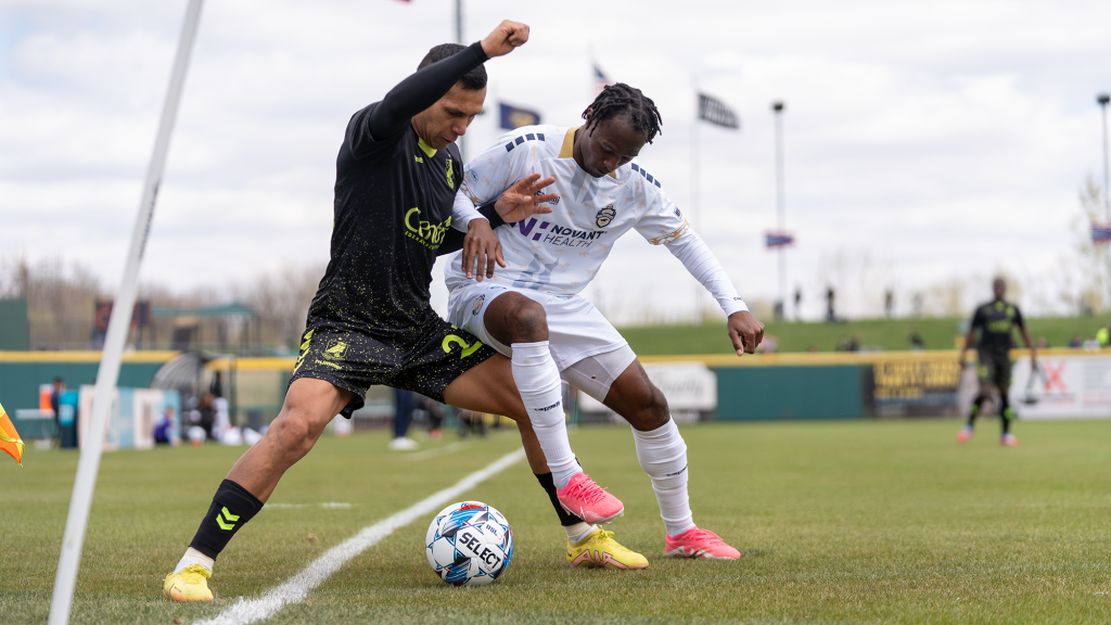Aaron Gomez fighting for ball against Charlotte Independence