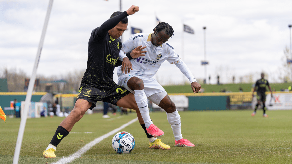 Aaron Gomez fighting for ball against Charlotte Independence