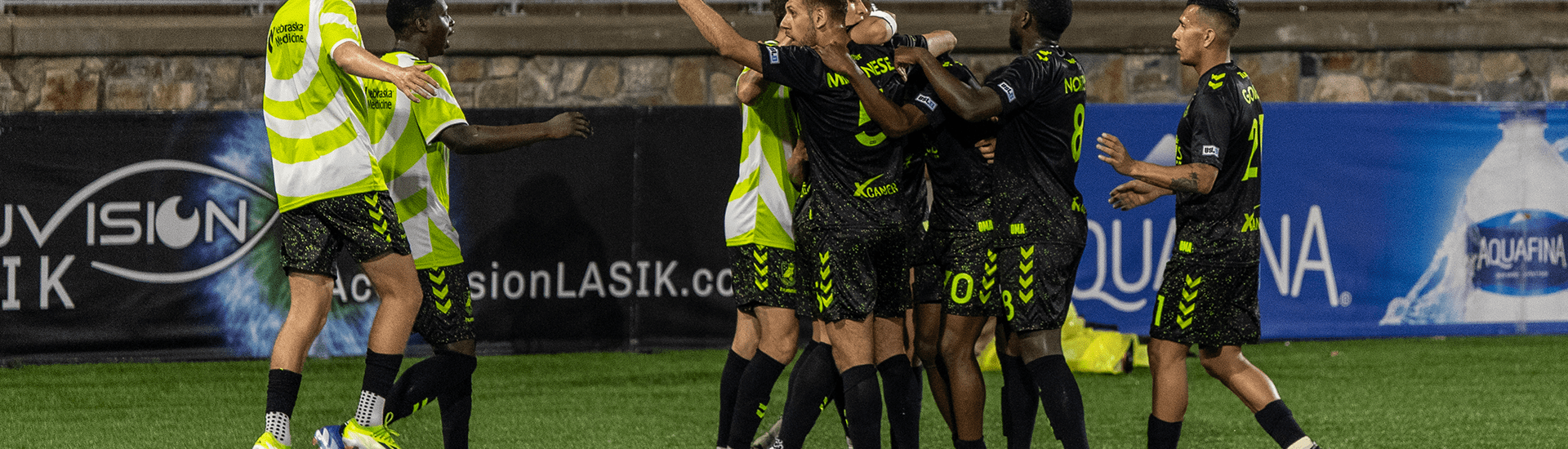 Union Omaha players celebrating a goal against Charlotte