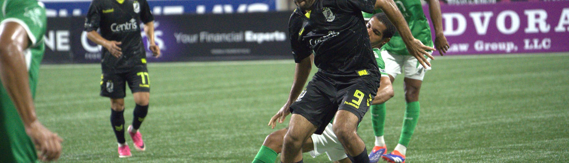 Pato Botello Faz shielding the ball against a New York Cosmos defender.